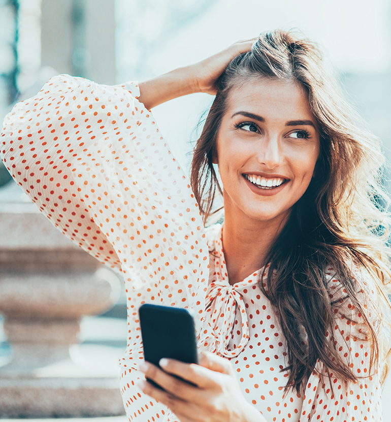 Happy woman using smart phone